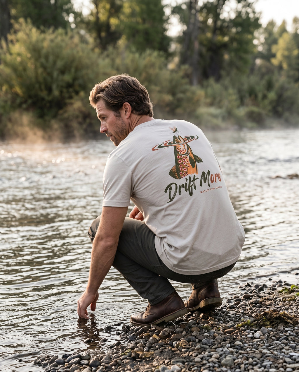 Match the Hatch Tee back print, heather dust, streamside on a Montana gravel bar