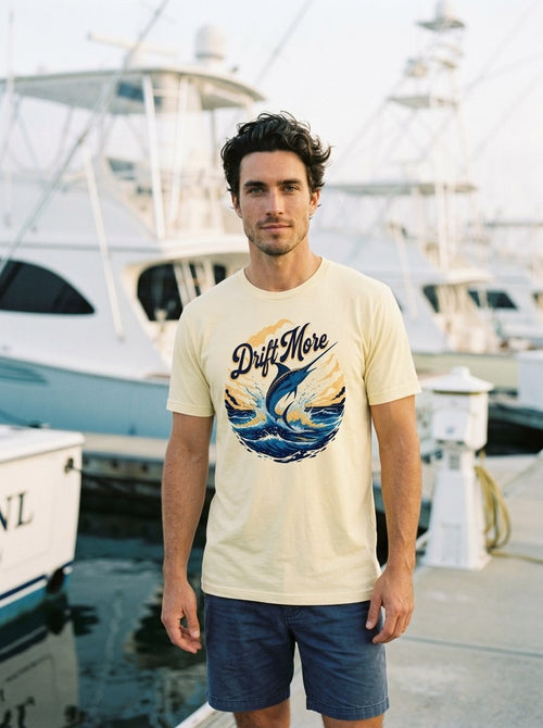 Blue Marlin Tee in Soft Cream worn on a fuel dock at golden hour